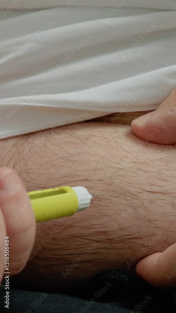 Vertical Screen: A man demonstrates how to inject insulin with a pen to manage diabetes. He carefully locates the injection site and performs the injection to control his blood sugar levels.