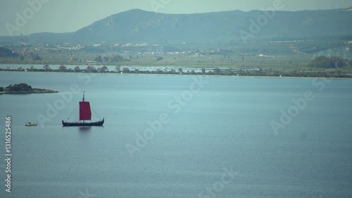 Greek trireme ancient rowed warship at calm blue sea