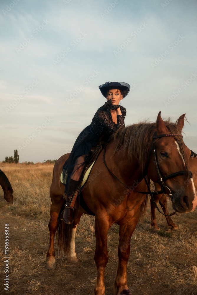elegant girl in long dress, gloves and hat upside down on horse, in the middle of field. elegant girl in long dress, gloves and hat upside down on horse, in the middle of field.