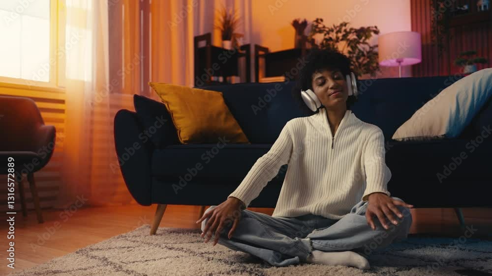 Happy African American female puts on a headset, enjoying her favorite music Happy African American female puts on a headset, enjoying her favorite music