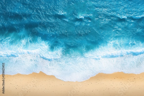 An overhead view of ocean waves meeting sandy beach shore