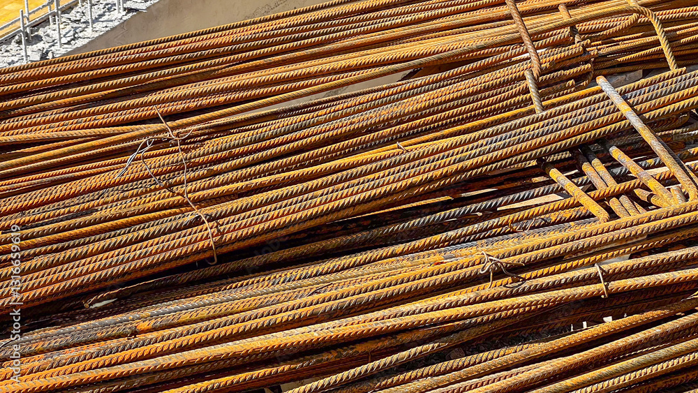 Rusty steel rebar stacked for construction, industrial architecture, building materials, metal strength background Rusty steel rebar stacked for construction, industrial architecture, building materials, metal strength background