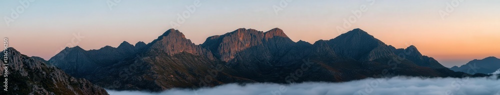 © BrandwayArt - Jagged mountain peaks rise into the dawn sky © BrandwayArt - Jagged mountain peaks rise into the dawn sky