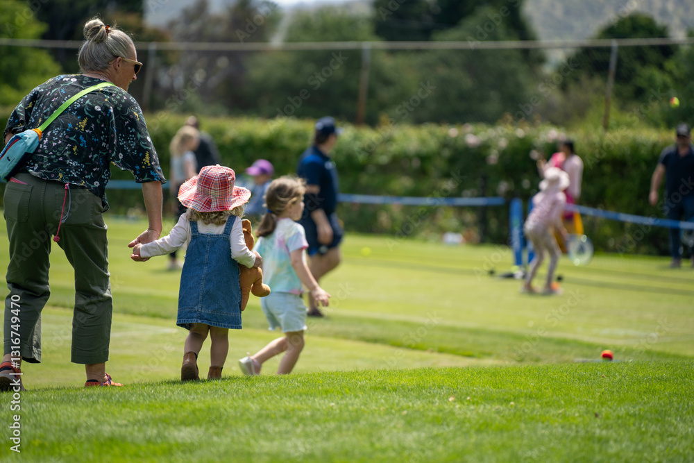 children play grass tennis in a lawn tennis court learning and having fun children play grass tennis in a lawn tennis court learning and having fun