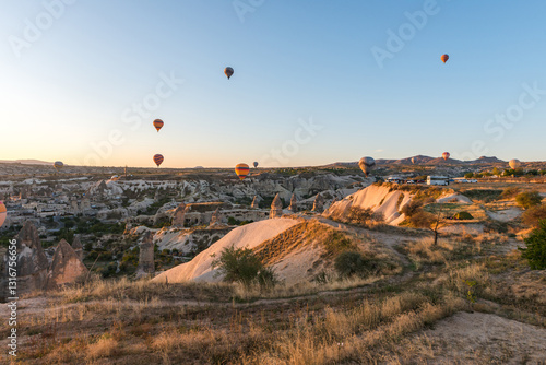 Colorful hot air balloon flying over Cappadocia, Turkey. Hot air balloons flying in sunrise sky.
