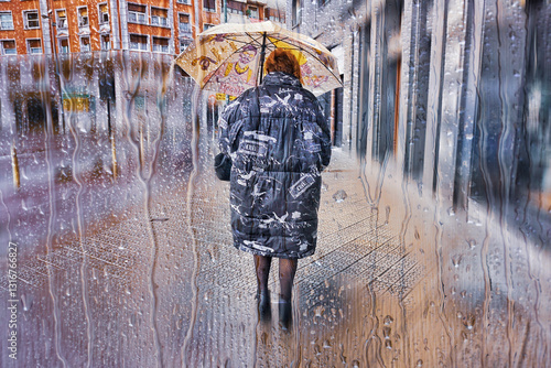 Pedestrian on the street with an umbrella in rainy days in winter season