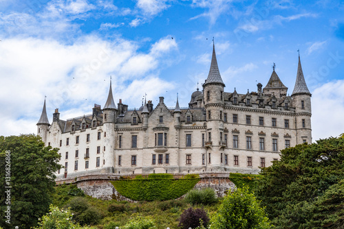 Dunrobin Castle, fairy-tale gem overlooking North Sea, offers breathtaking gardens, exquisite summer blooms. A masterpiece of elegance, lush landscapes meet historic charm, unfold on manicured lawns photo