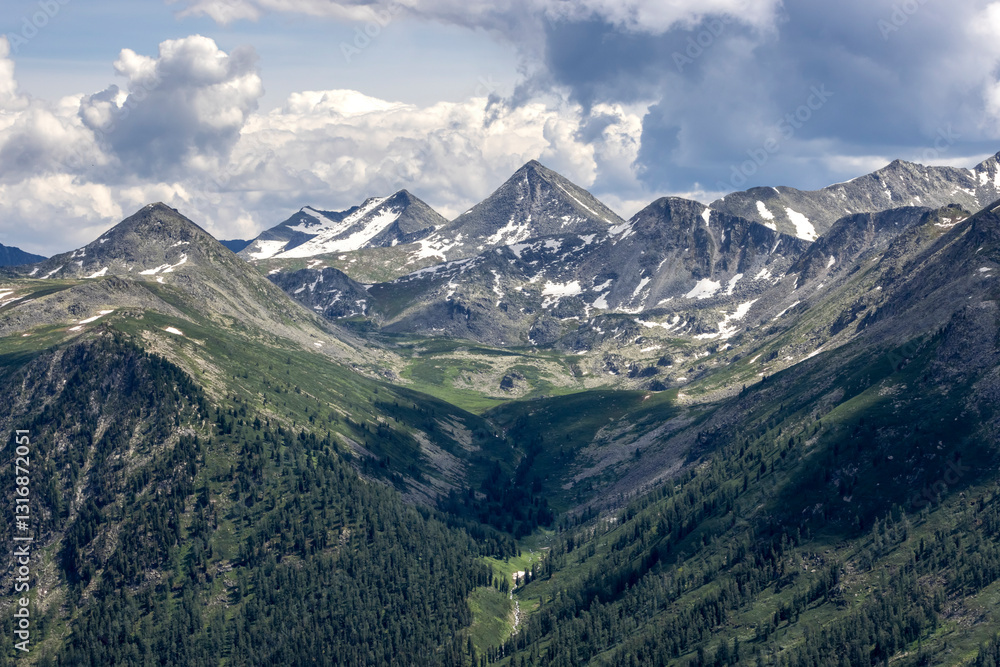 snow-capped mountain hills and dark rainy sky
