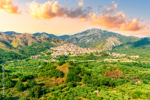 Bild auf Leinwand amazing mountain landscape with old yellow italian town among green beatiful mou