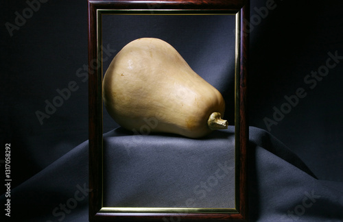 Still life with a pumpkin on a gray background and a photo frame photo