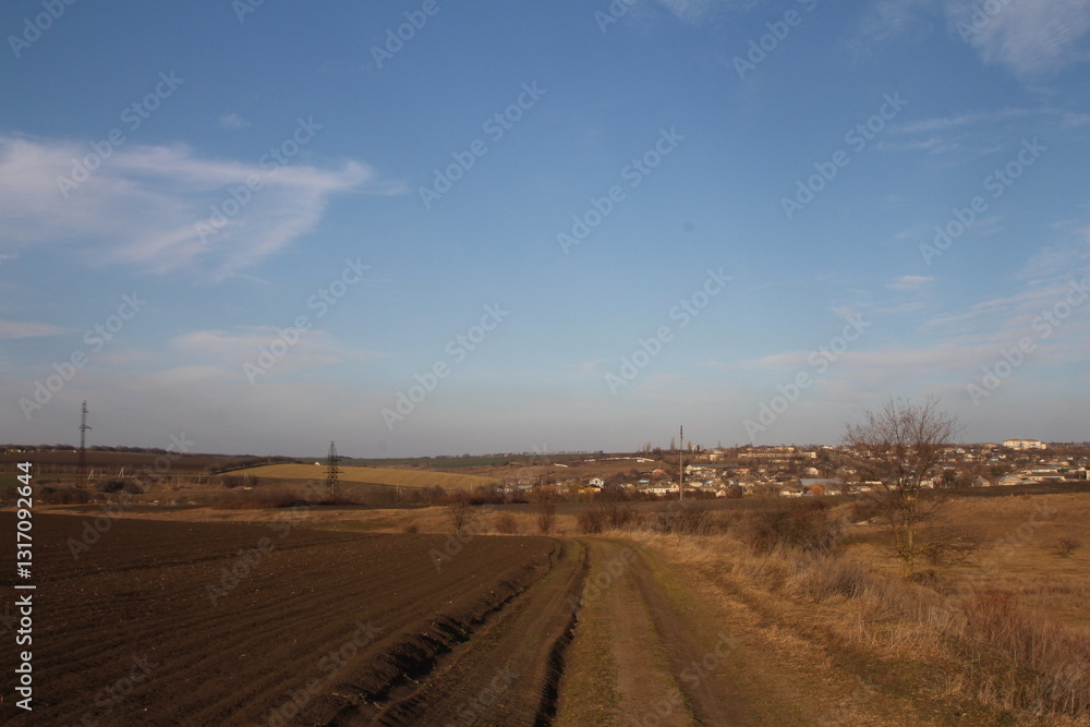 Obraz premium A dirt road with a sign on it