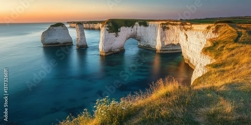 Fototapeta Naklejka Na Ścianę i Meble -  Breathtaking landscape with dramatic white chalk formations rising from turquoise-blue waters, with golden grassy cliffs and stunning sunset lighting. Generative AI