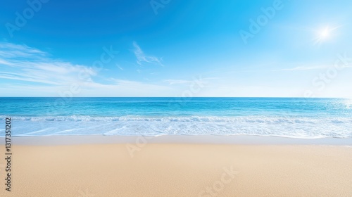 Vast sandy beach with clear blue sky, serene coastal paradise for relaxation and tranquility