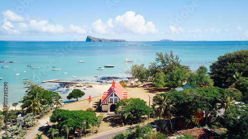 Stunning aerial view of Gunner's Quoin (Coin de Mire) Island and the iconic red-roofed church on the beach at Cap Malheureux, Mauritius
