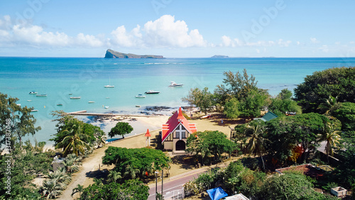 Stunning aerial view of Gunner's Quoin (Coin de Mire) Island and the iconic red-roofed church on the beach at Cap Malheureux, Mauritius