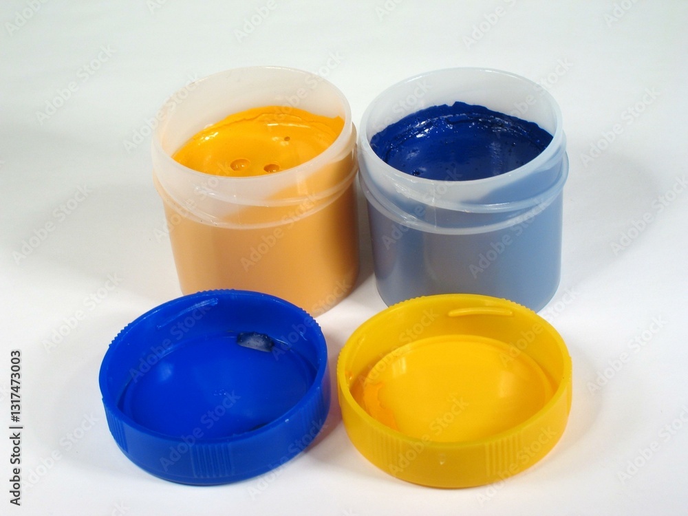 Colored paint cans over white background