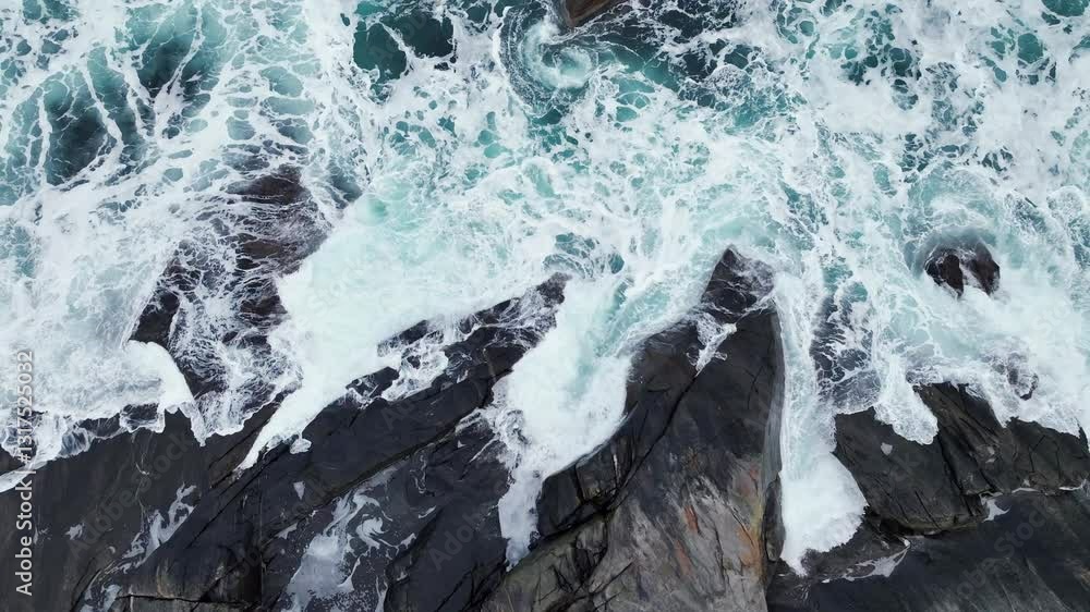 vertical shot of ocean surf, breaking on the rocky coast of Senja Island in northern Norway vertical shot of ocean surf, breaking on the rocky coast of Senja Island in northern Norway