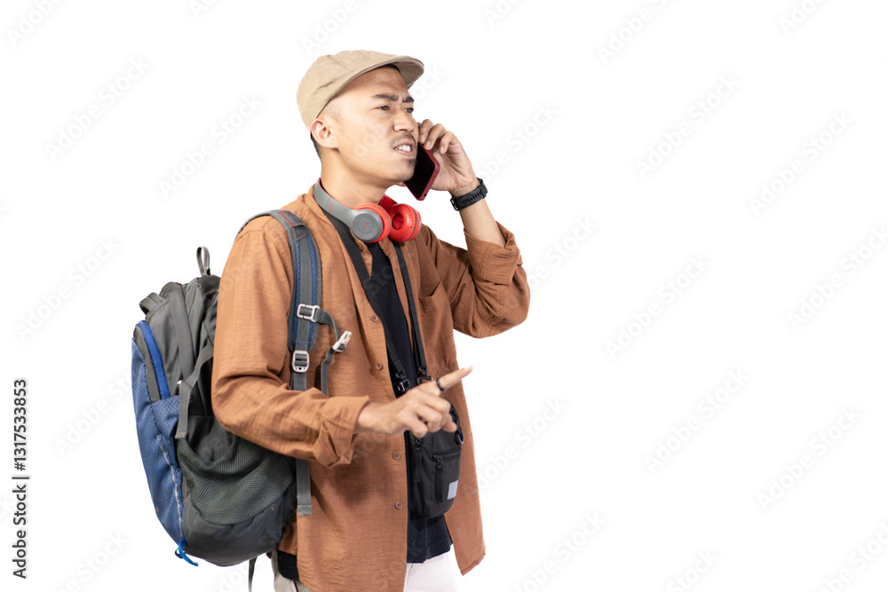 Young Indonesian male traveler looking disappointed and angry while on voice call while traveling, travel concept, isolated on white background. Young Indonesian male traveler looking disappointed and angry while on voice call while traveling, travel concept, isolated on white background.