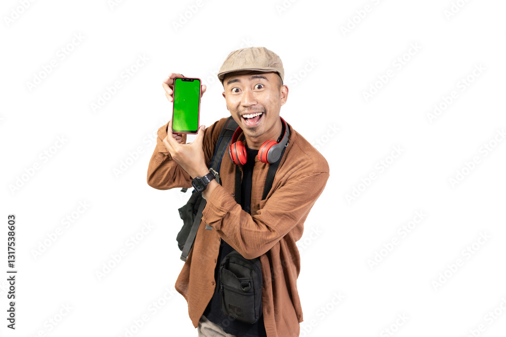 young indonesian male traveler showing green mobile phone screen to camera, copy space and travel advertisement, travel concept, isolated on white background. young indonesian male traveler showing green mobile phone screen to camera, copy space and travel advertisement, travel concept, isolated on white background.