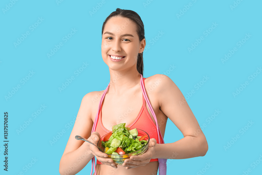Beautiful young happy woman with jumping rope and bowl of fresh salad on blue background. Weight loss concept Beautiful young happy woman with jumping rope and bowl of fresh salad on blue background. Weight loss concept