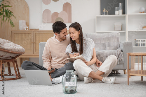 Young couple with jar of mo...