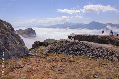 Mar de nubes en alta montaña con personas photo