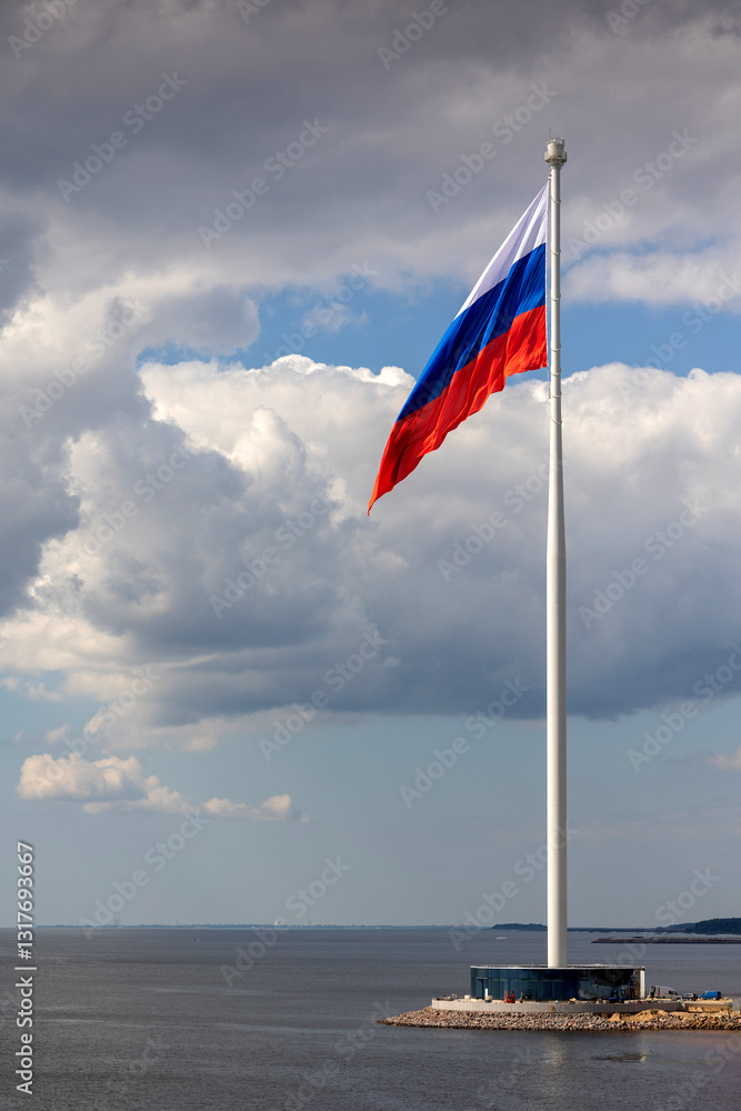 Fototapeta premium Flag of Russian Federation is flying in air on blue sky and white cumulus clouds. National flag of Russian. vertical photo.