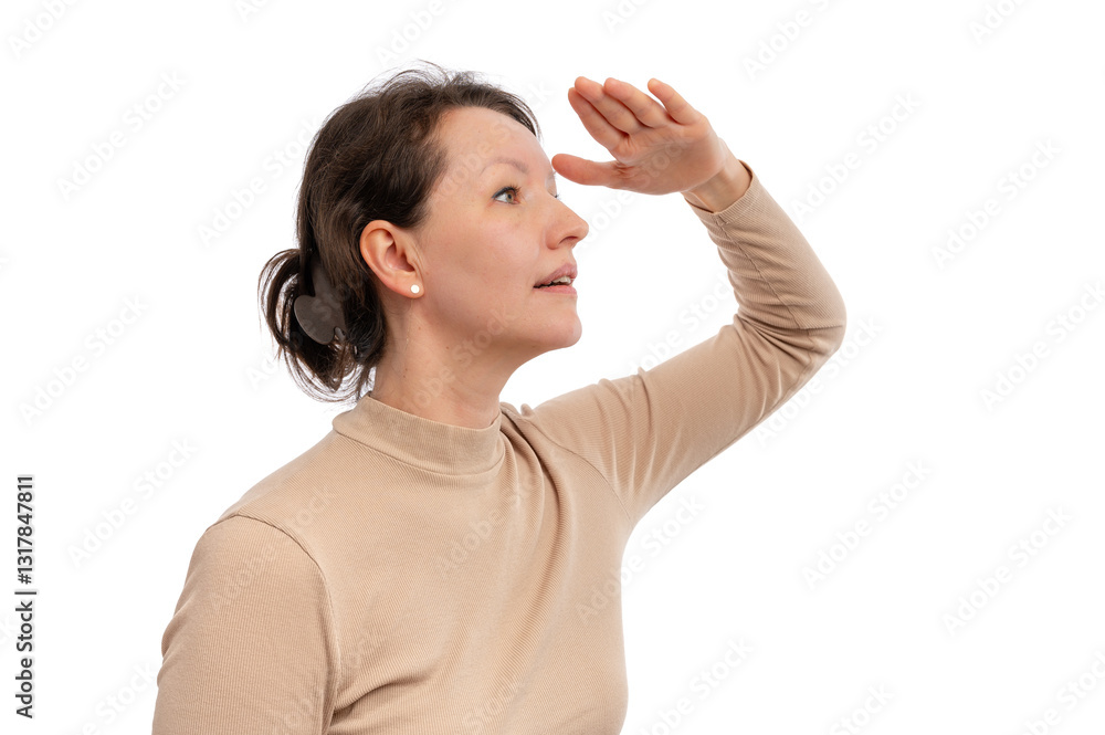 A woman in a beige turtleneck shielding her eyes while looking ahead against a white background. A woman in a beige turtleneck shielding her eyes while looking ahead against a white background.