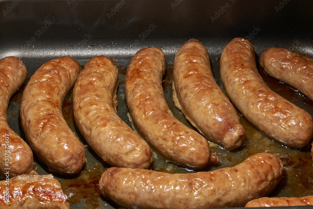 Sausages with cheese, baked in the oven. Close-up. Sausages with cheese, baked in the oven. Close-up.