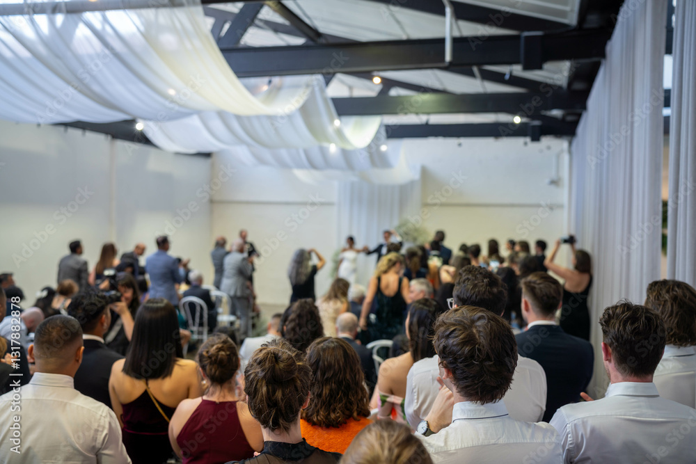 people watching at an event inside people watching at an event inside