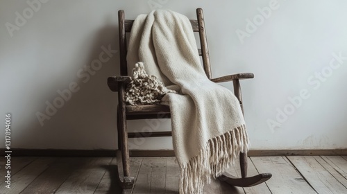 A white blanket draped over a wooden rocking chair.