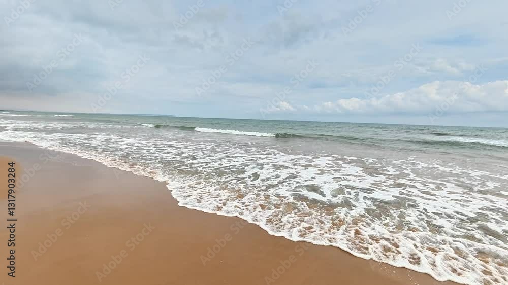 A tranquil and picturesque beach scene showcasing gentle waves gracefully lapping against the soft, golden sand A tranquil and picturesque beach scene showcasing gentle waves gracefully lapping against the soft, golden sand