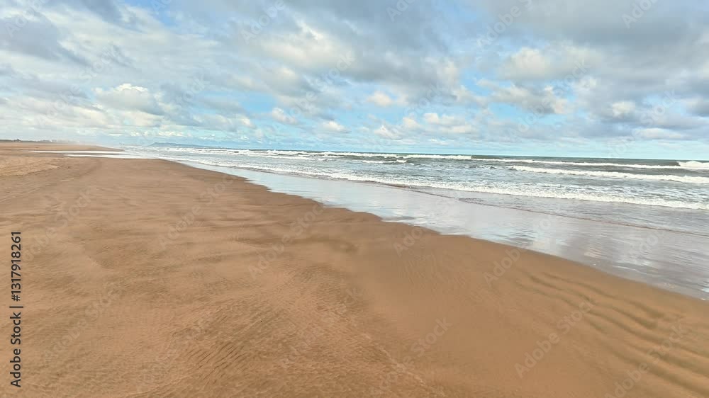 A tranquil beach view featuring soft golden sands, gentle waves rolling in, and a vibrant colorful sky above A tranquil beach view featuring soft golden sands, gentle waves rolling in, and a vibrant colorful sky above