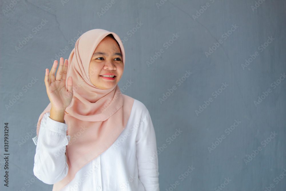 Portrait of woman standing while waving smiling on gray background. Portrait of woman standing while waving smiling on gray background.