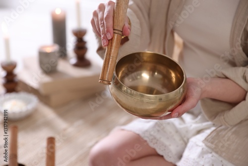 Konstfotografi Woman with singing bowl and burning candles indoors, closeup