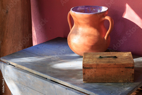 Europe, Spain, Balearic Islands, Mallorca. Esporles. Old table with pottery urn and wooden box.