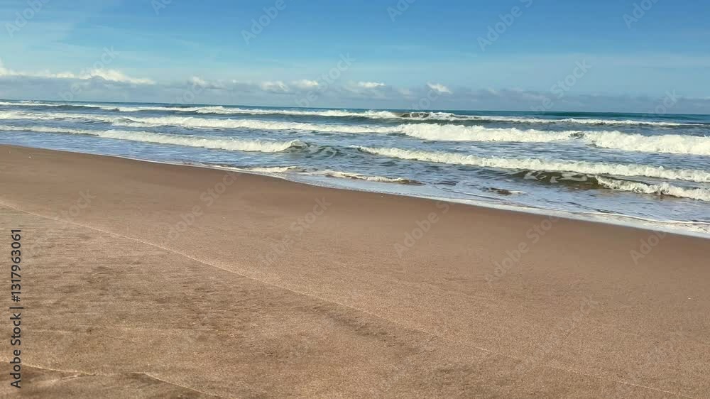 A tranquil beach view showcasing gentle waves lapping against soft sand beneath a clear blue sky overhead A tranquil beach view showcasing gentle waves lapping against soft sand beneath a clear blue sky overhead