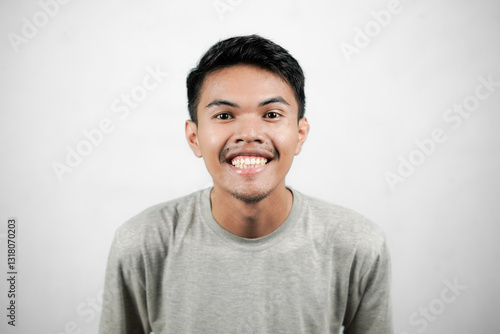 Portrait of asian man showing excited expression, young man isolated on white background
