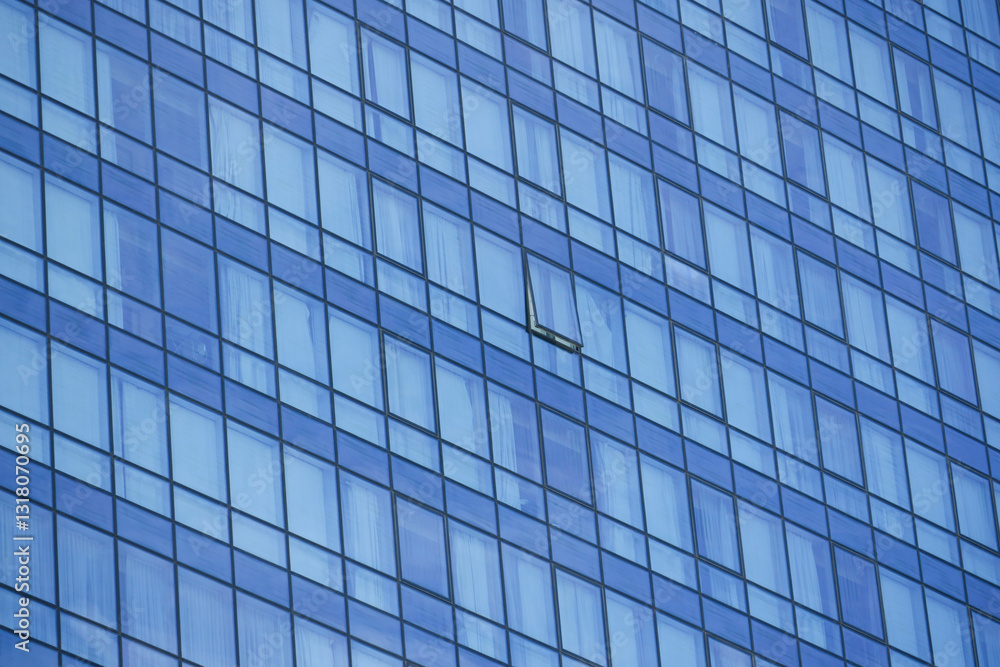 Modern building facade with reflections of sky and missing window Modern building facade with reflections of sky and missing window