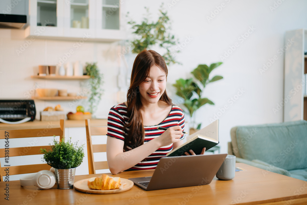 woman working remotely on a laptop and tablet in a cozy kitchen workspace. Perfect for education, freelance woman working remotely on a laptop and tablet in a cozy kitchen workspace. Perfect for education, freelance