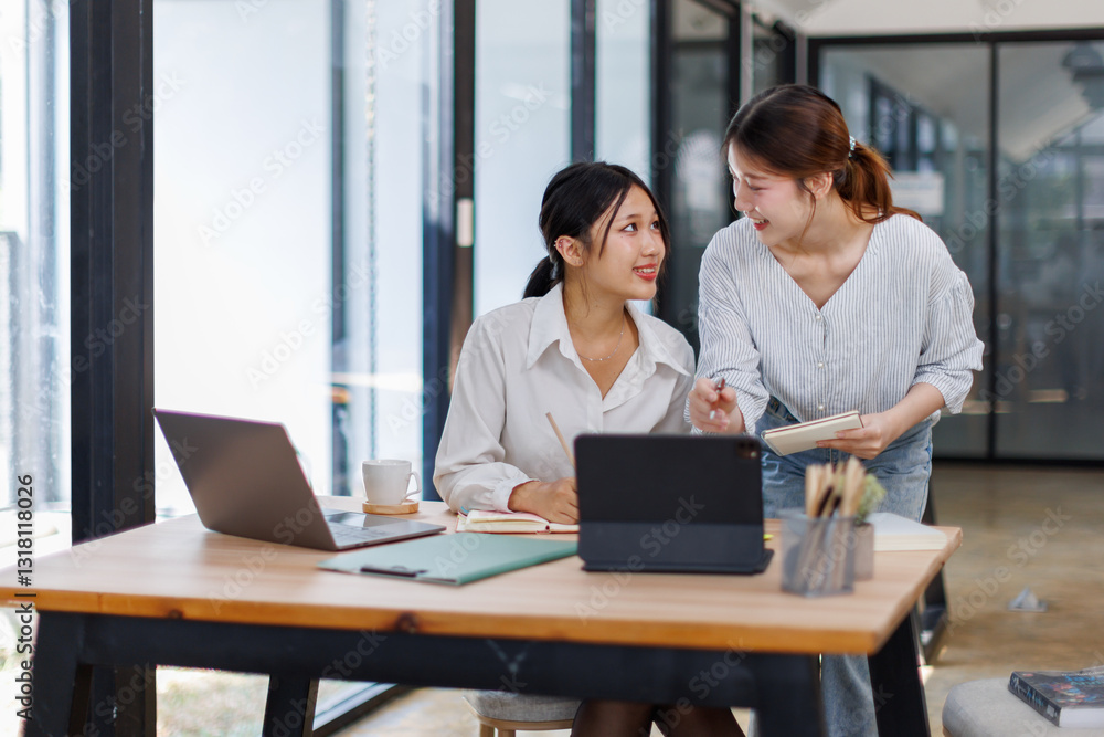 Two smiling happy asian businesswomen working together on a laptop in the office, demonstrating teamwork business meeting in a corporate and collaboration
Two smiling happy asian businesswomen working together on a laptop in the office, demonstrating teamwork business meeting in a corporate and collaboration