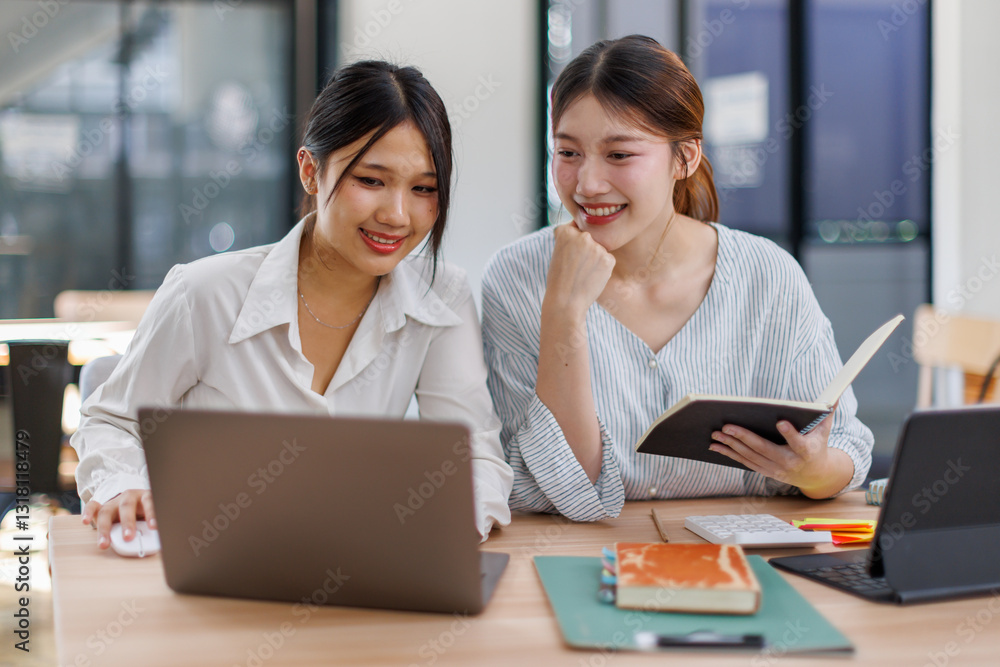 Happy professional young women collaborating with enthusiasm in a modern office setting. Two asian female entrepreneurs using a laptop for a productive business meeting in a corporate workplace.
Happy professional young women collaborating with enthusiasm in a modern office setting. Two asian female entrepreneurs using a laptop for a productive business meeting in a corporate workplace.