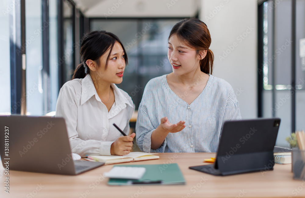Happy professional young women collaborating with enthusiasm in a modern office setting. Two asian female entrepreneurs using a laptop for a productive business meeting in a corporate workplace.
Happy professional young women collaborating with enthusiasm in a modern office setting. Two asian female entrepreneurs using a laptop for a productive business meeting in a corporate workplace.