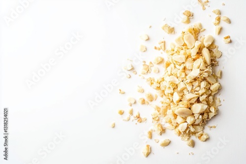 Heap of crushed macadamia nuts on a white background in top down view for recipe ingredient ideas