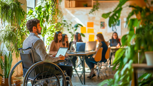 A young businessman with a disability holds a meeting in the office in front of the assembled employees.
