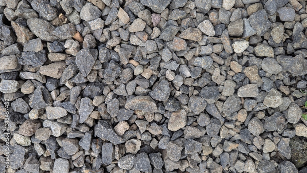 A high-angle shot reveals a textured expanse of small, irregularly shaped gravel stones, creating a natural, abstract pattern A high-angle shot reveals a textured expanse of small, irregularly shaped gravel stones, creating a natural, abstract pattern