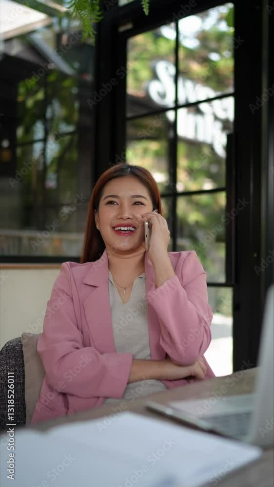 Businesswoman talking on the phone in a natural-themed office, expressing ideas with gestures, professional communication. Businesswoman talking on the phone in a natural-themed office, expressing ideas with gestures, professional communication.