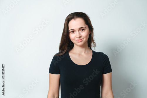 Konstfotografi Smiling girl of Slavic appearance 20 years old looking at camera isolated on gray background