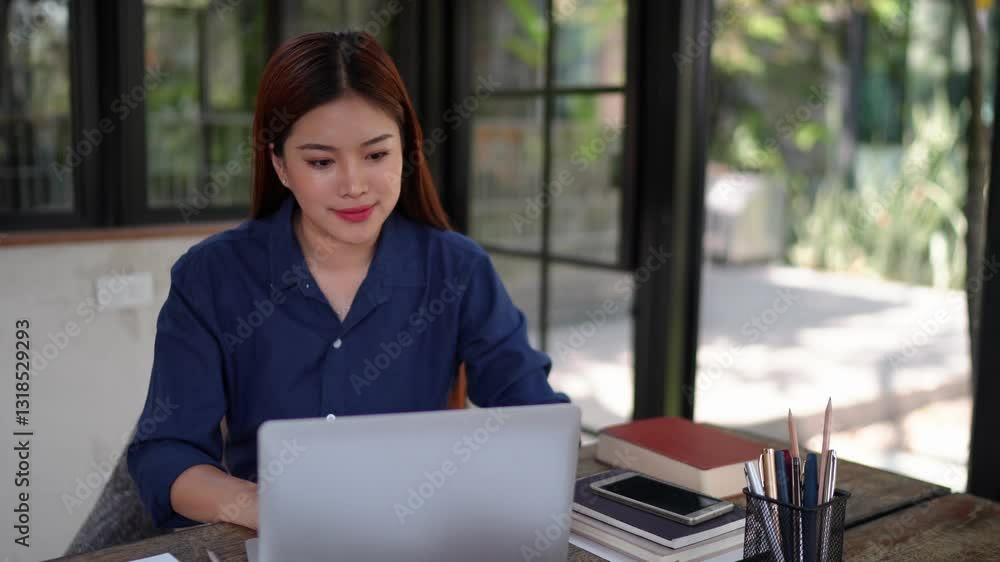 Businesswoman analyzing documents at a natural-themed office with a laptop, focused and dedicated to her work. Businesswoman analyzing documents at a natural-themed office with a laptop, focused and dedicated to her work.