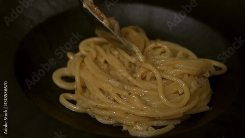 Chef prepares pasta carbonara. Slow motion.